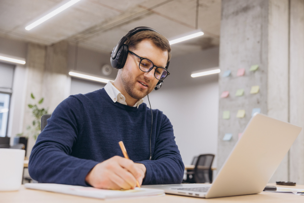 Image of a man at a laptop listening to an Ageing Australia webinar.